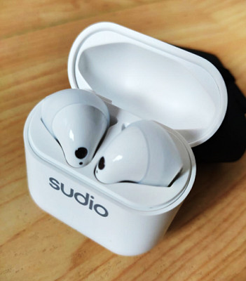 Sudio Nio earbuds with wingtips inside casing